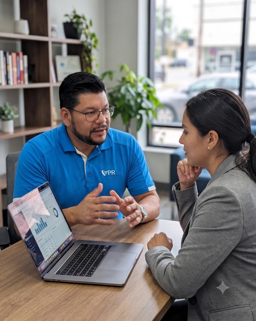 Cesar Rincon discussing coverage questions with a client in his office
